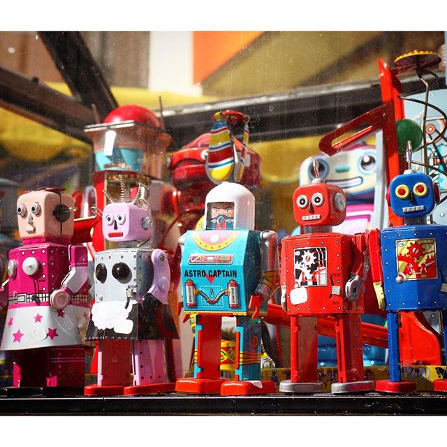 Tin toy robots at a street market in Paris, France