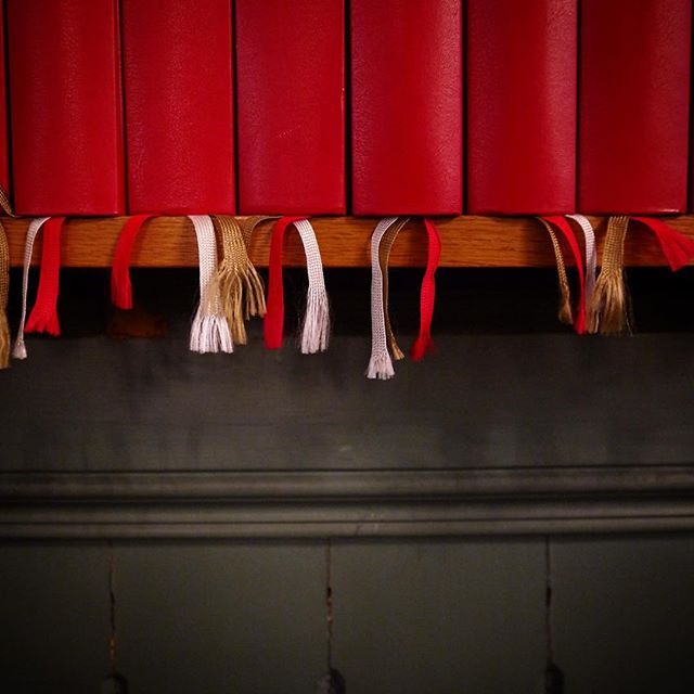 Close up of prayer books in Kristiansand, Norway church, red and gray with white